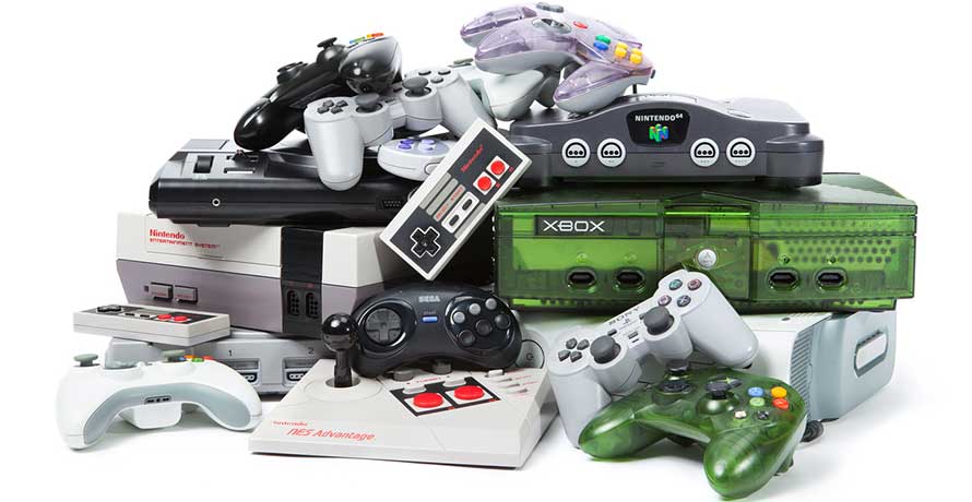 Stacked collection of retro and modern video game consoles with controllers, including NES, Nintendo 64, Xbox, and PlayStation systems